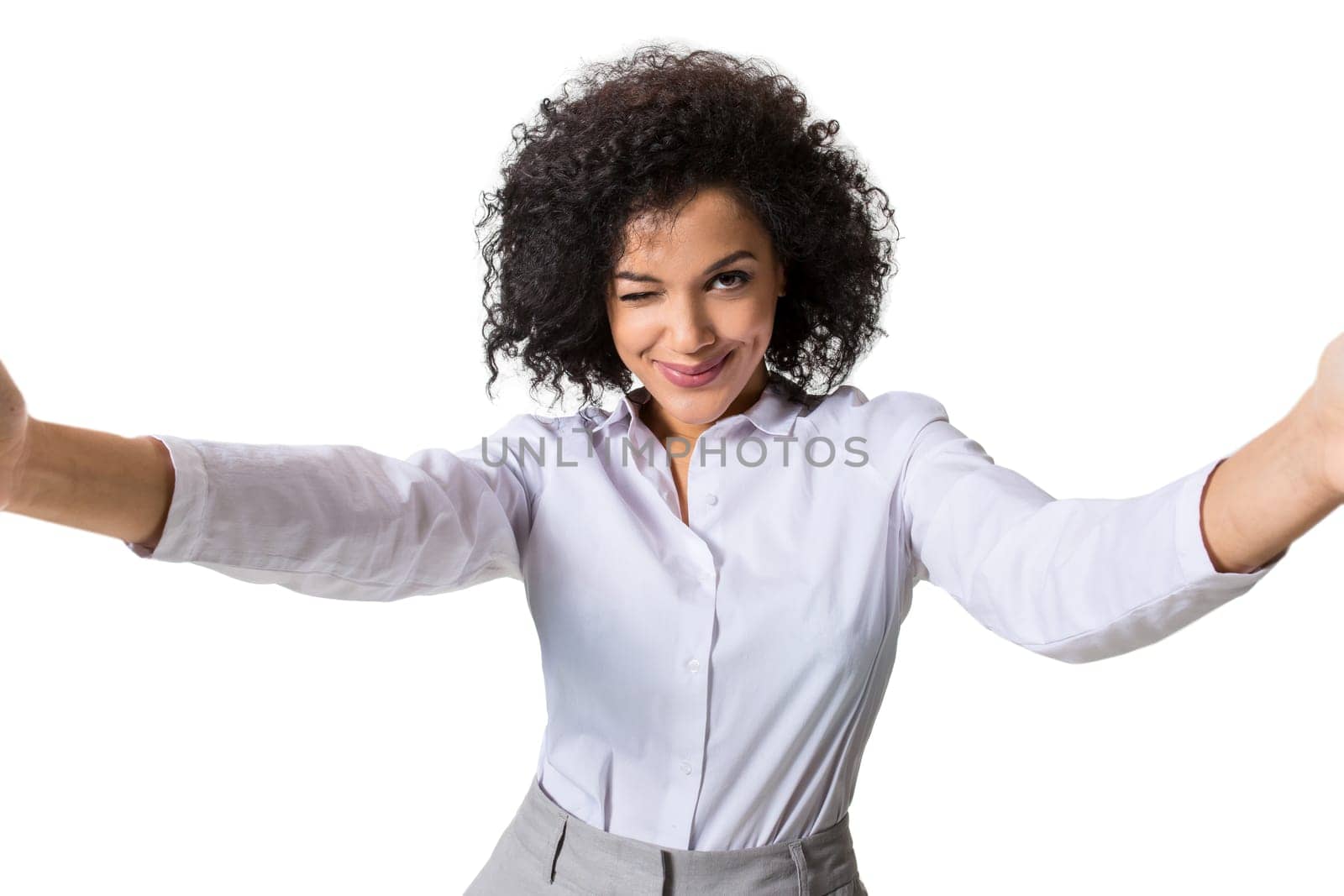 Young beautiful African American woman makes self against the white background in studio by nazarovsergey