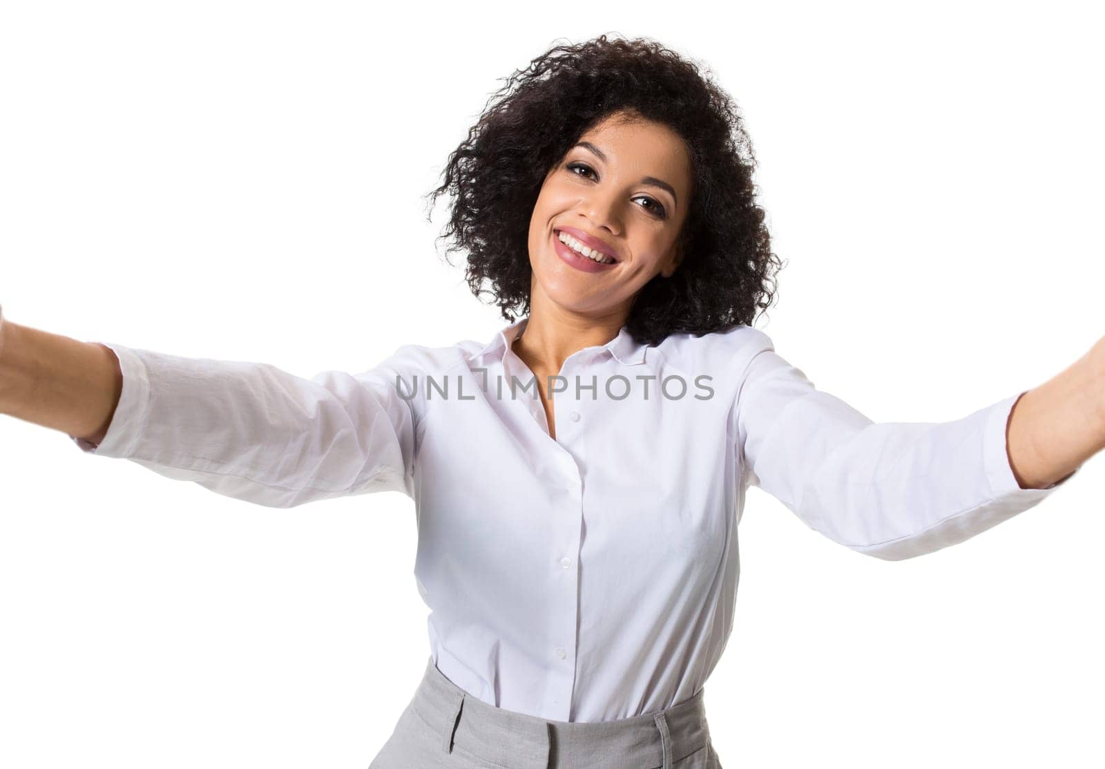 Young beautiful African American woman makes self against the white background in studio. Emotions. Isolated on white background