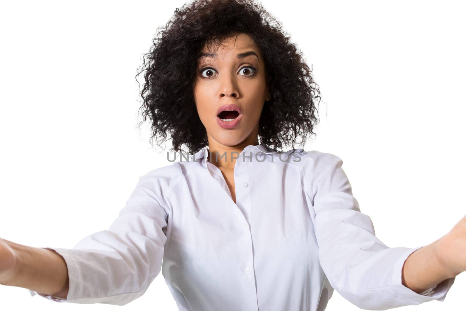 Young beautiful African American woman makes self against the white background in studio. Emotions. Isolated on white background