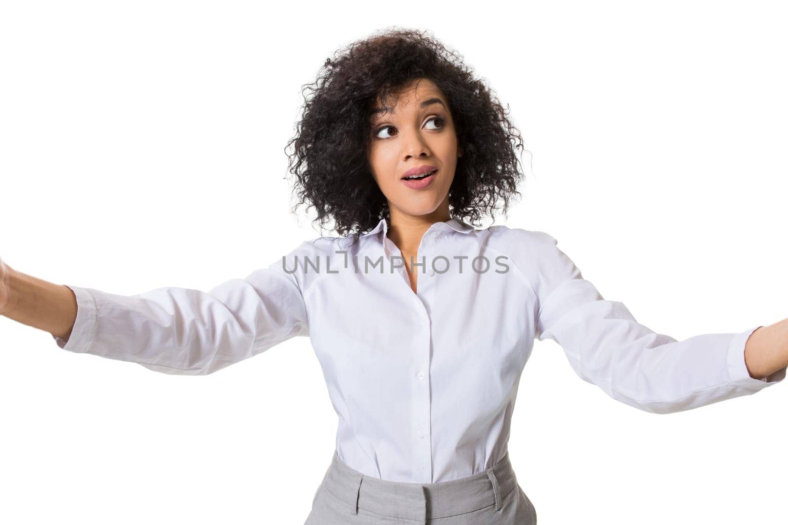 Young beautiful African American woman makes self against the white background in studio. Emotions. Isolated on white background