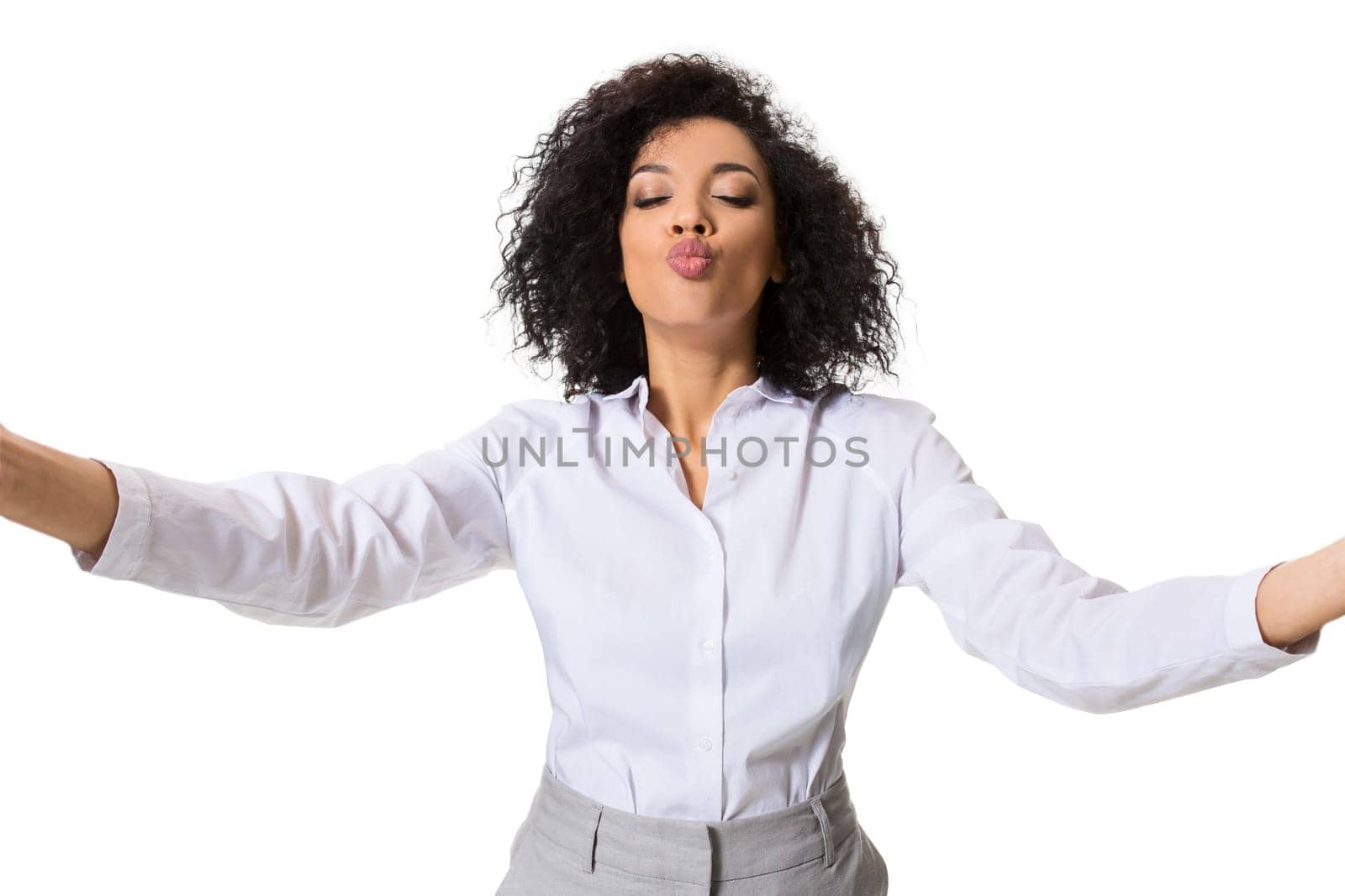 Young beautiful African American woman makes self against the white background in studio. Emotions. Isolated on white background