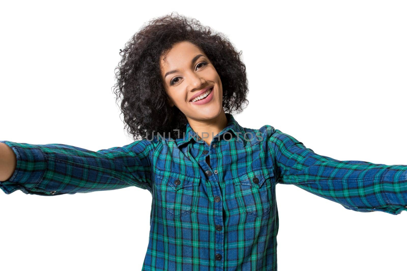 Young beautiful African American woman makes self against the white background in studio by nazarovsergey