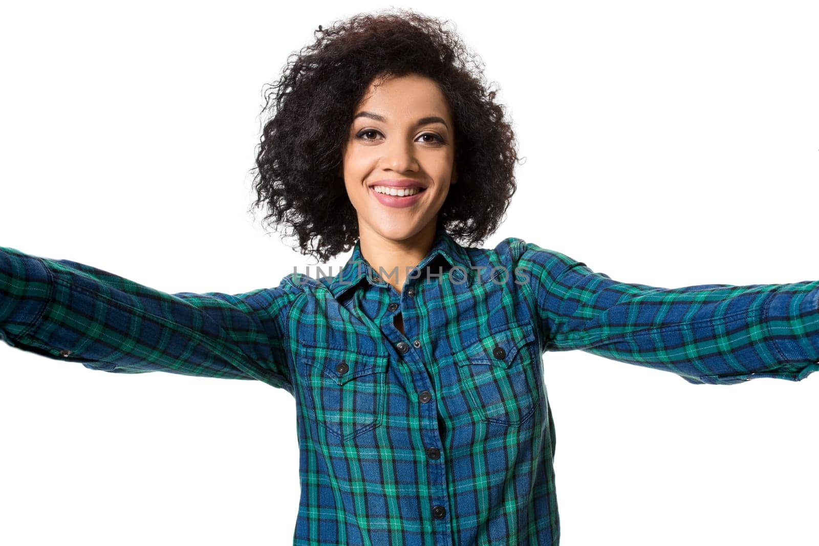 Young beautiful African American woman makes self against the white background in studio by nazarovsergey