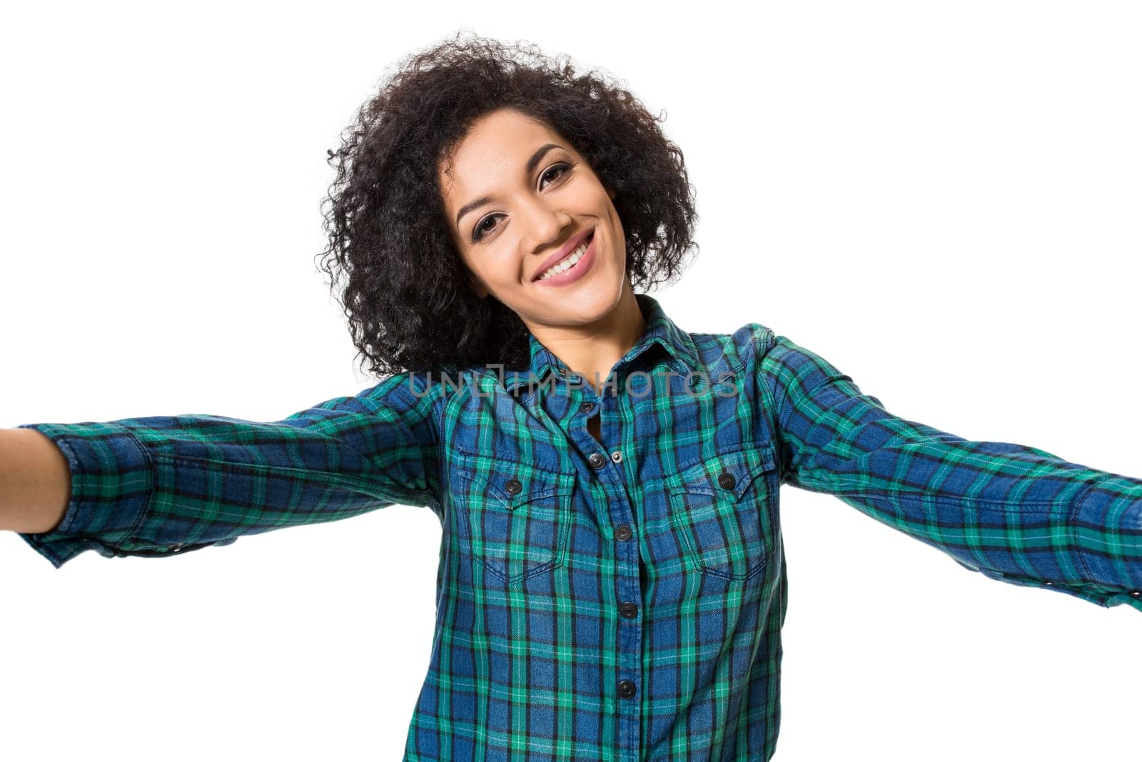 Young beautiful African American woman makes self against the white background in studio. Emotions. Isolated on white background