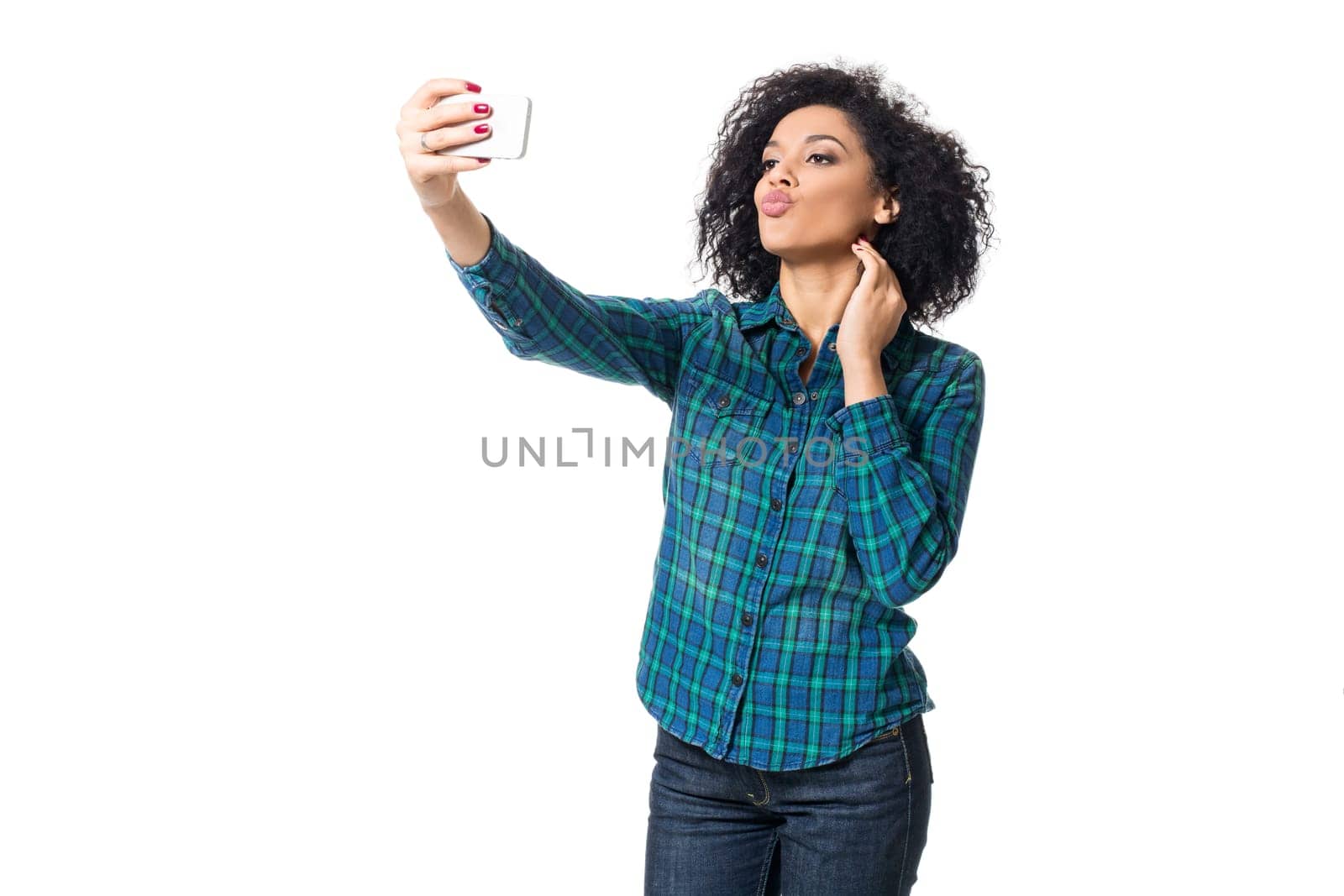 Young woman in blue shirt makes selfie on a white background. isolated
