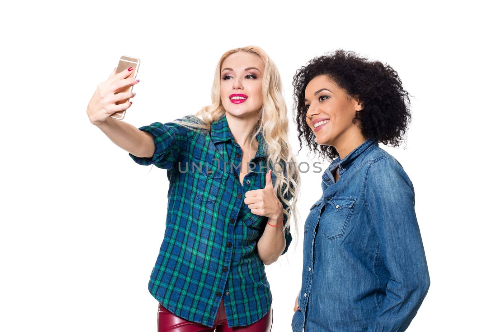 Two beautiful girls making selfie. Isolated on white background