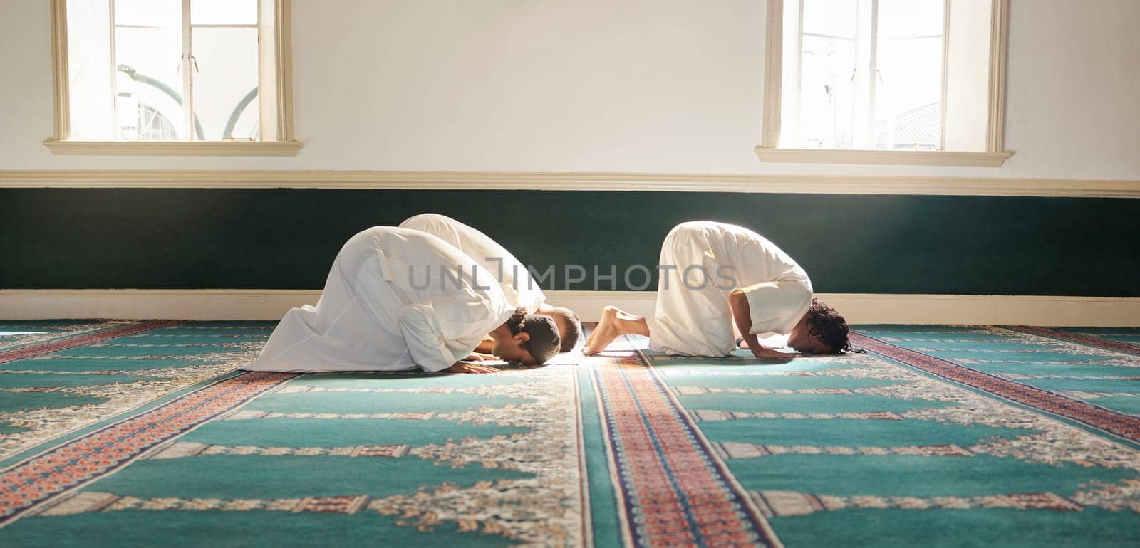 Muslim, prayer and mosque with a spiritual man group praying together during fajr, dhuhr or asr, otherwise maghrib or ishaa. Salah, worship and pray with islamic friends observing ramadan tradition.