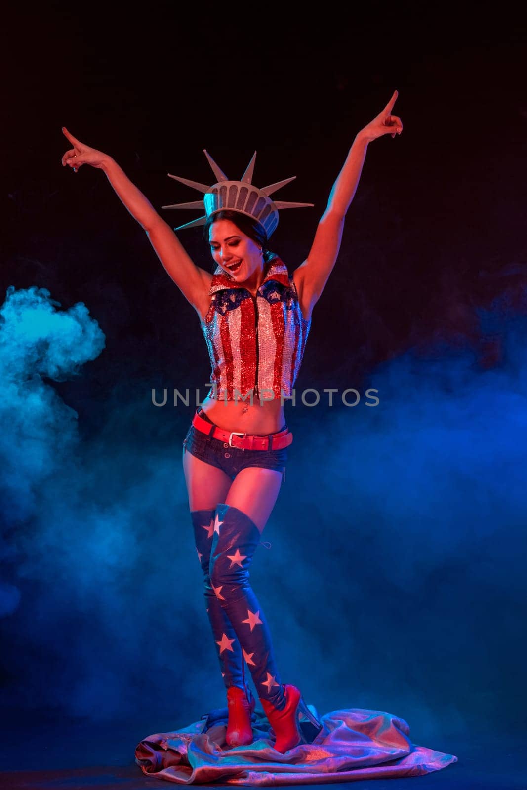 Woman in a scenic suit on stage. The American diva