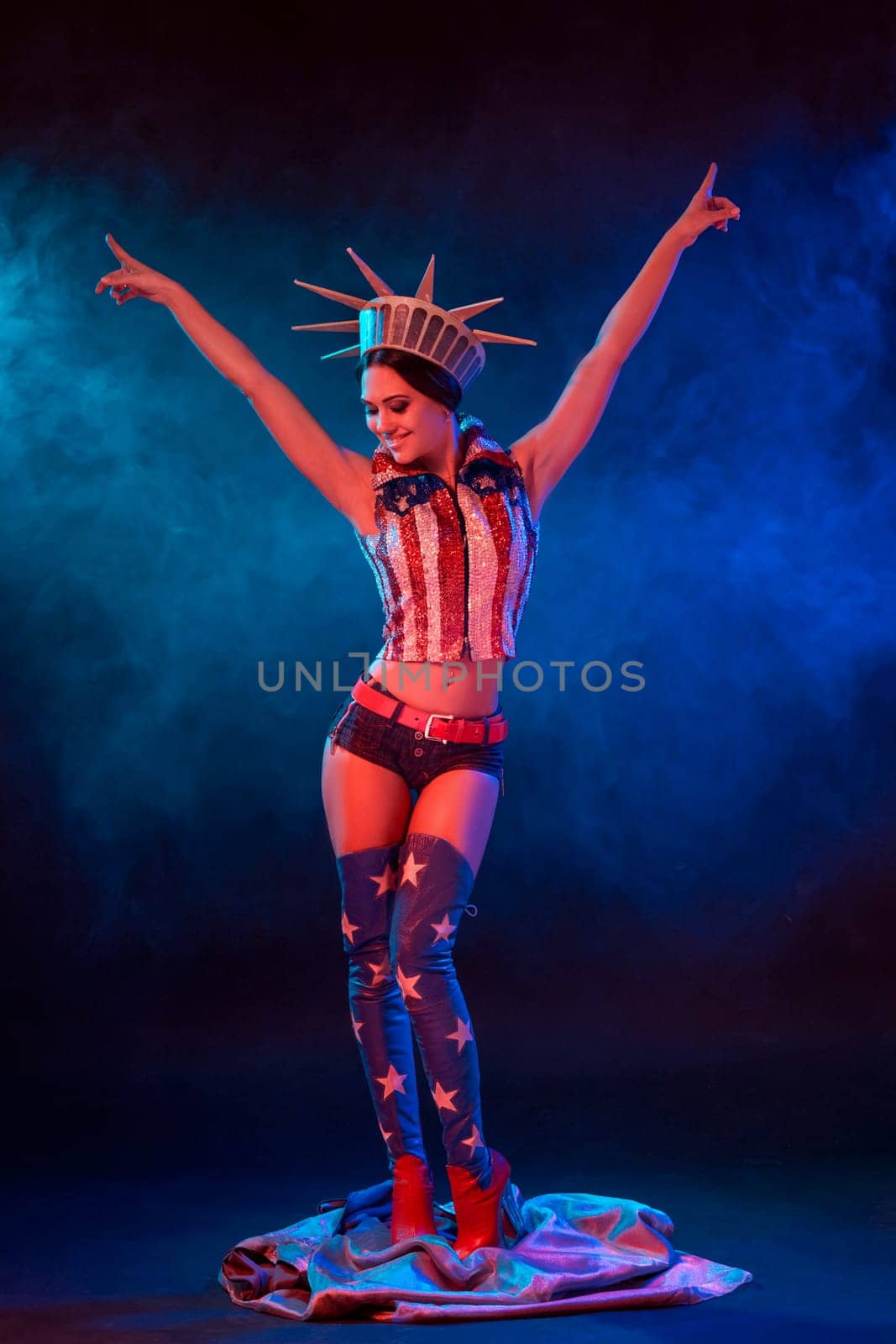 Young woman in stage costume of striptease dancer posing. Sexy woman in a statue of America costume