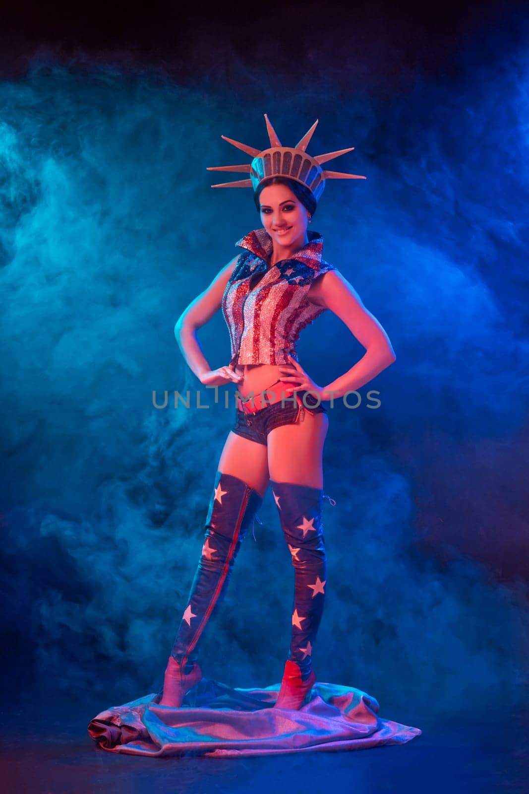 Young woman in stage costume of striptease dancer posing. Sexy woman in a statue of America costume