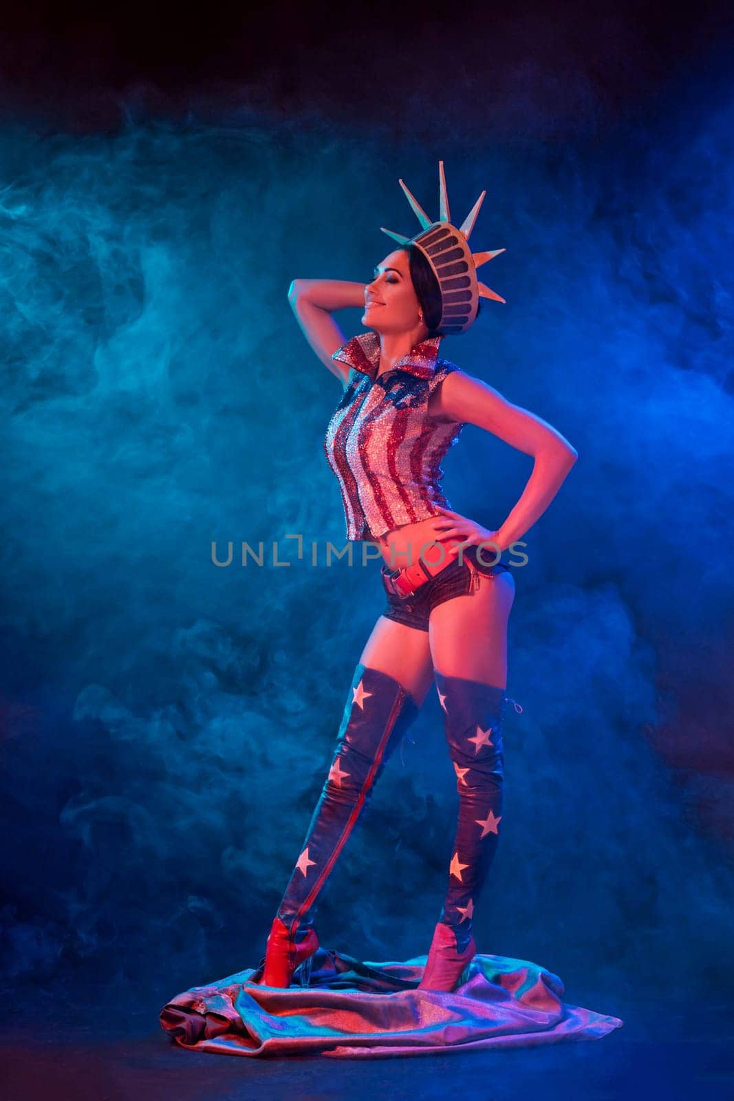 Young woman in stage costume of striptease dancer posing. Sexy woman in a statue of America costume