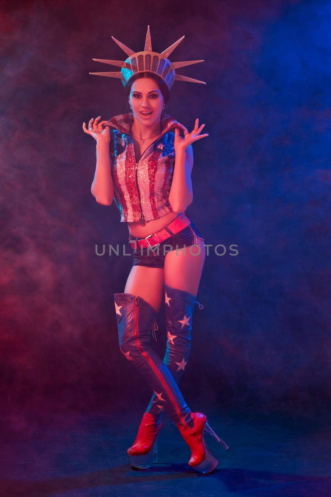 Young woman in stage costume of striptease dancer posing. Sexy woman in a statue of America costume