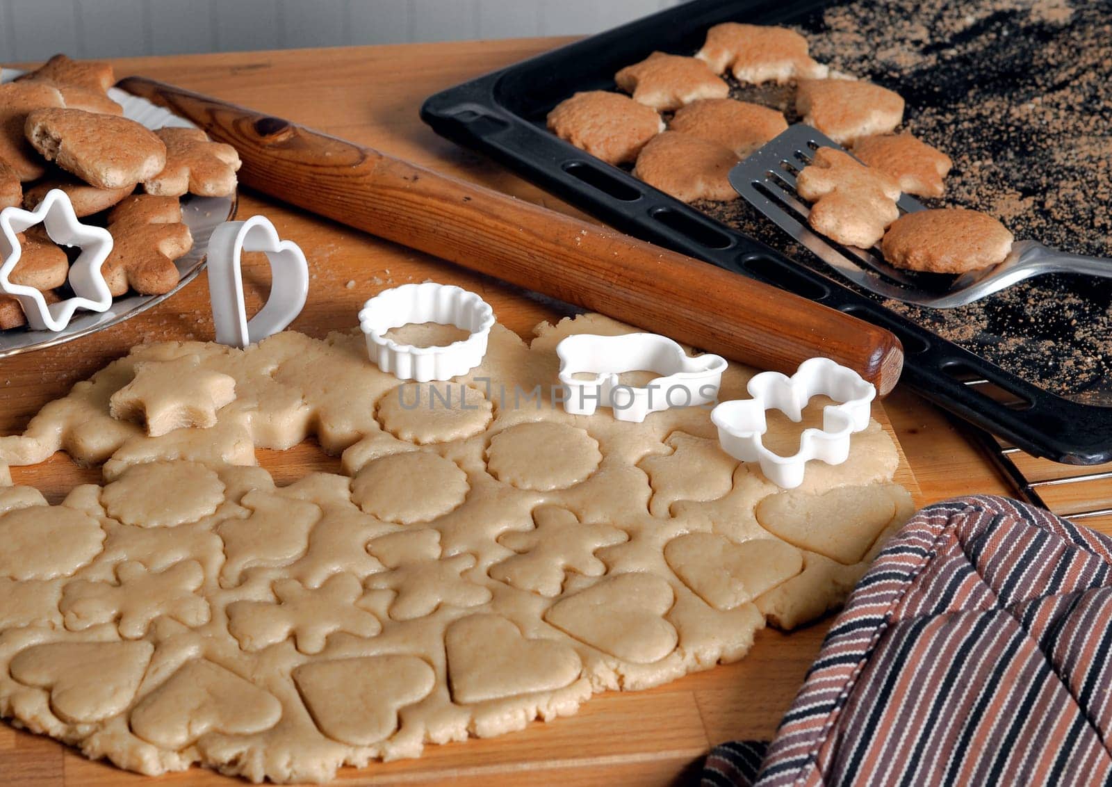 Food background with homemade cookies. The process of making cookies in the kitchen with dough and molds. The concept of fresh baking and healthy homemade food.