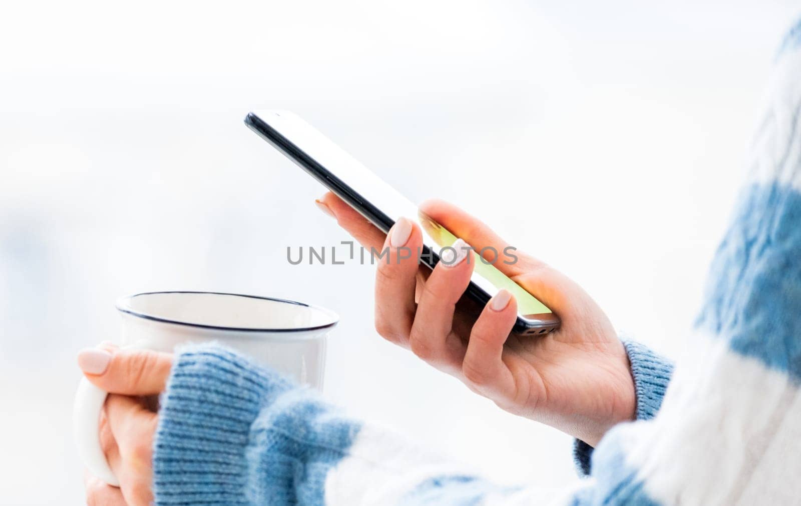 Hands holding cup and phone by GekaSkr