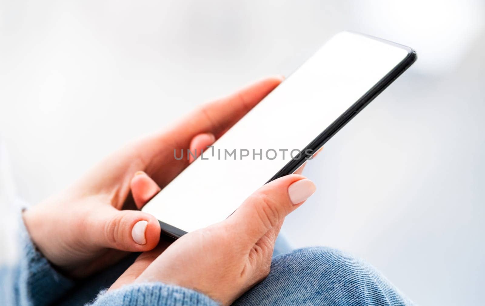 Hand holding mobile phone with white screen