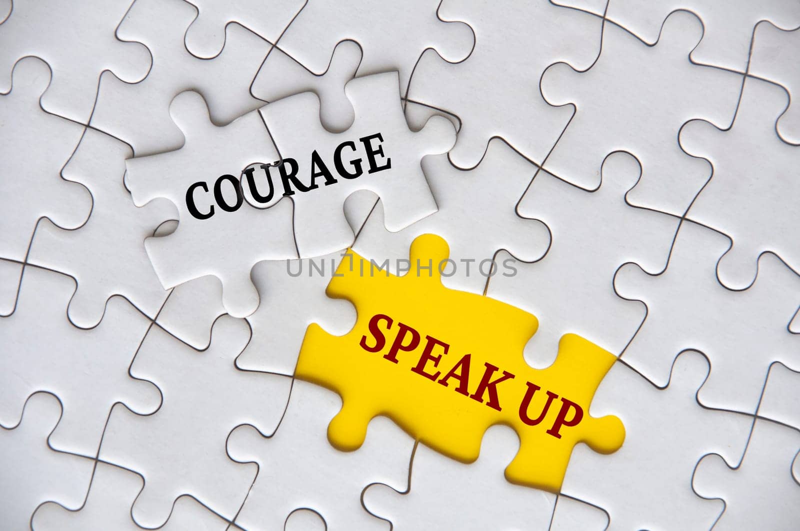 Courage to speak up text on missing jigsaw puzzle representing business culture in exercising speak up. by yom98