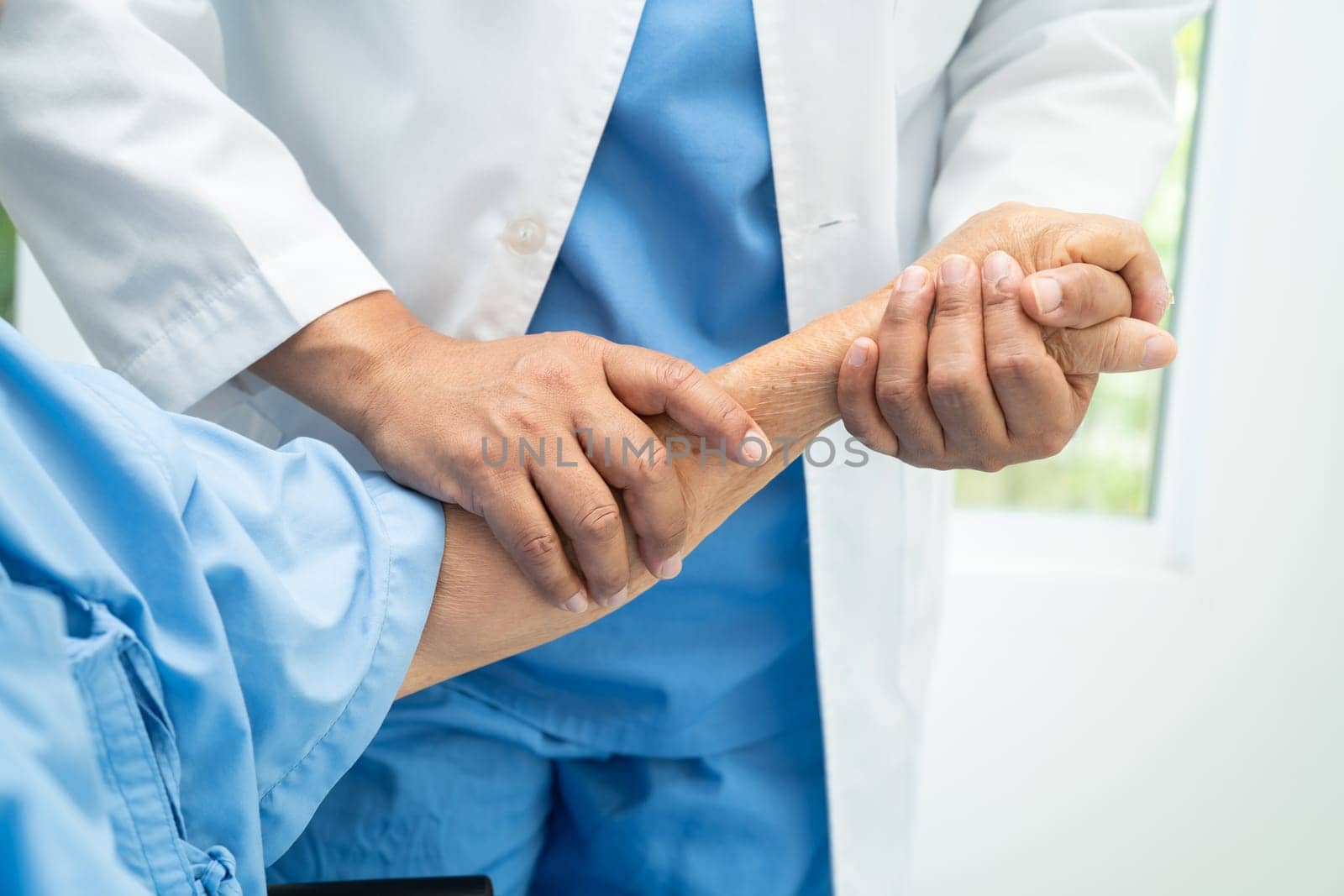 Caregiver holding hands Asian elderly woman patient with love, care, encourage and empathy at nursing hospital, healthy strong medical concept.