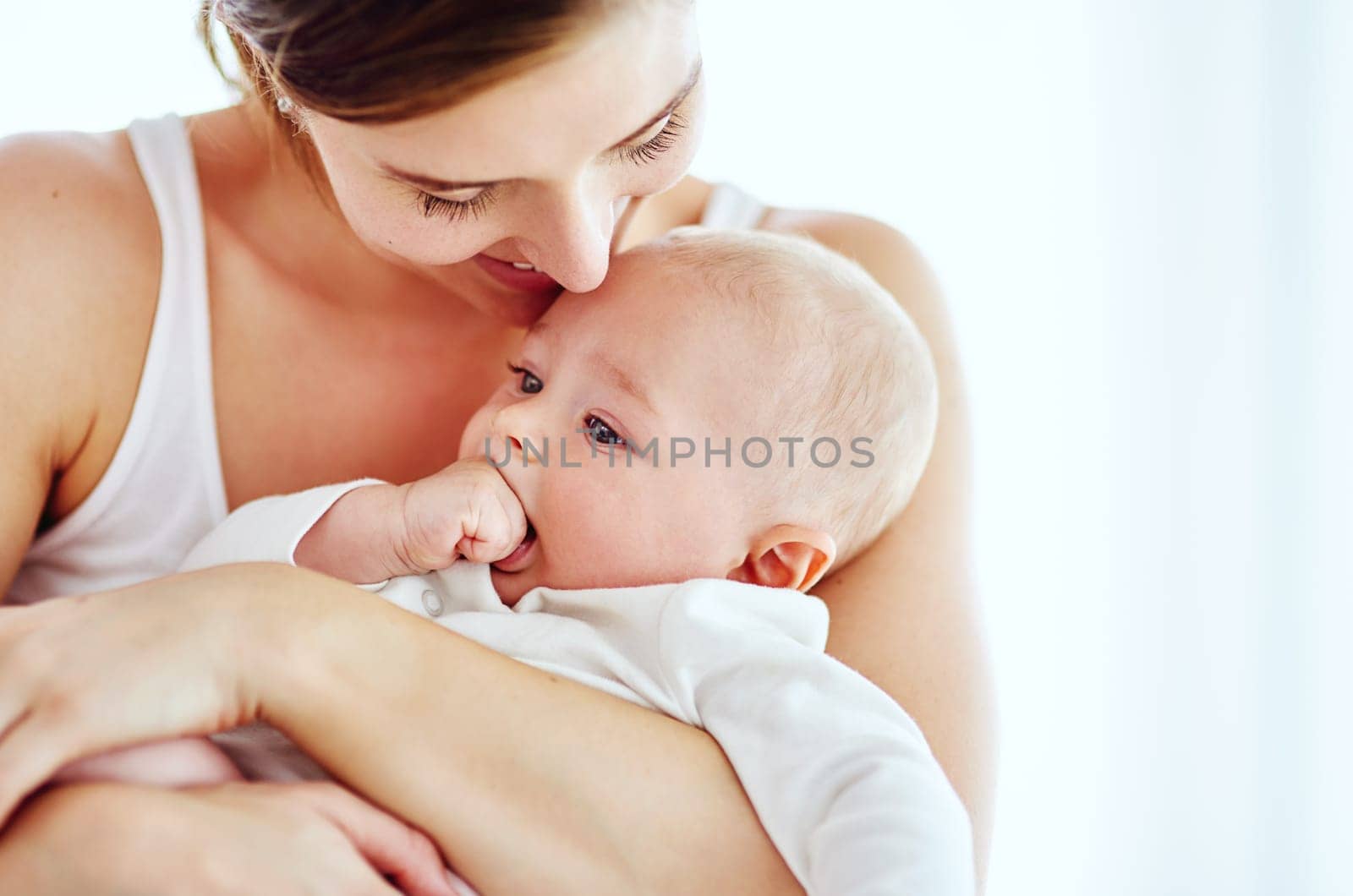 Shot of an adorable baby boy bonding with his mother at home.