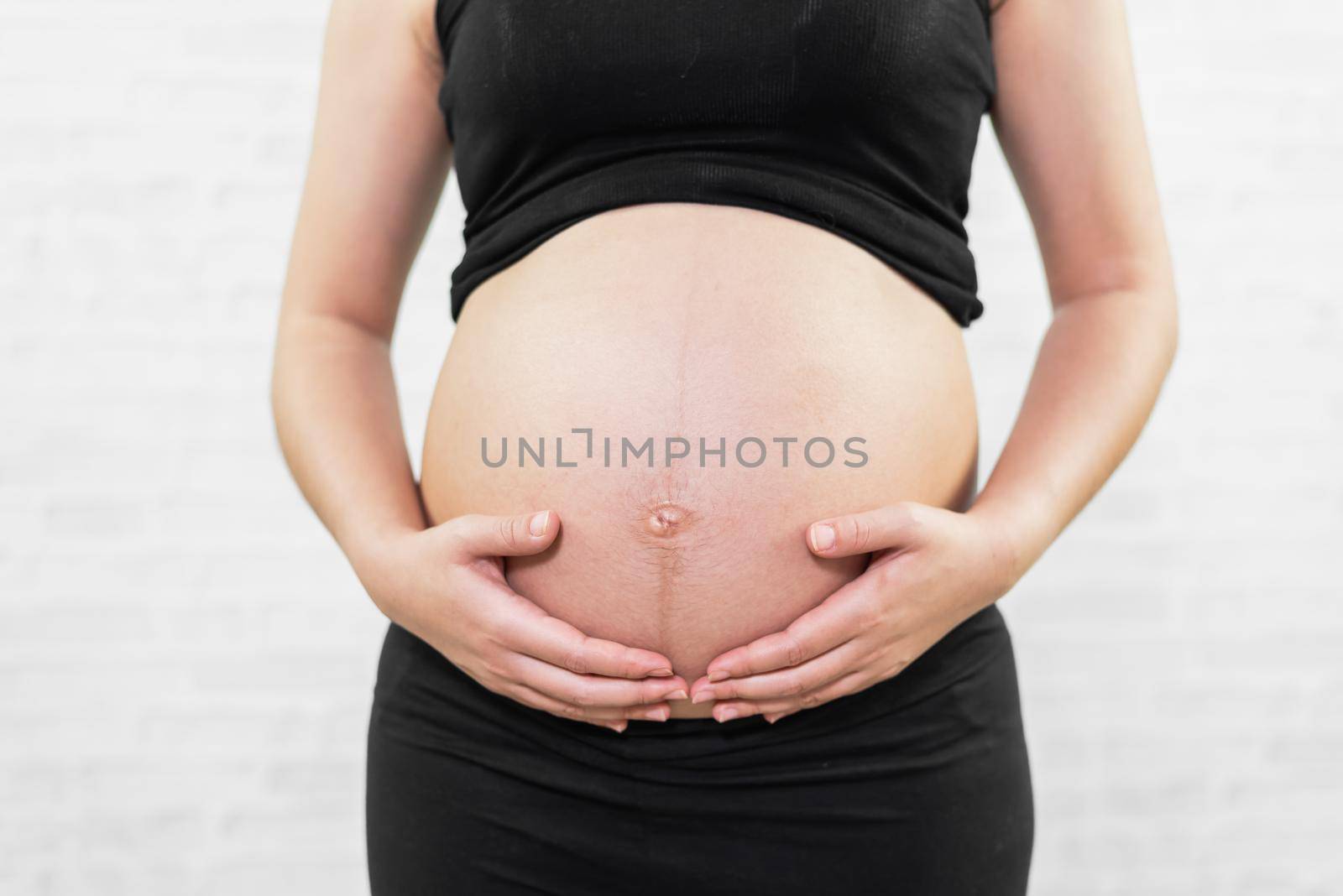 pregnant women holding belly on white background, pregnant women concept by Wmpix