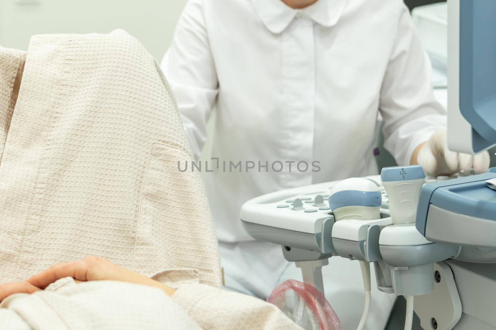 Doctor operating Ultrasound scanner for a patient diagnostic