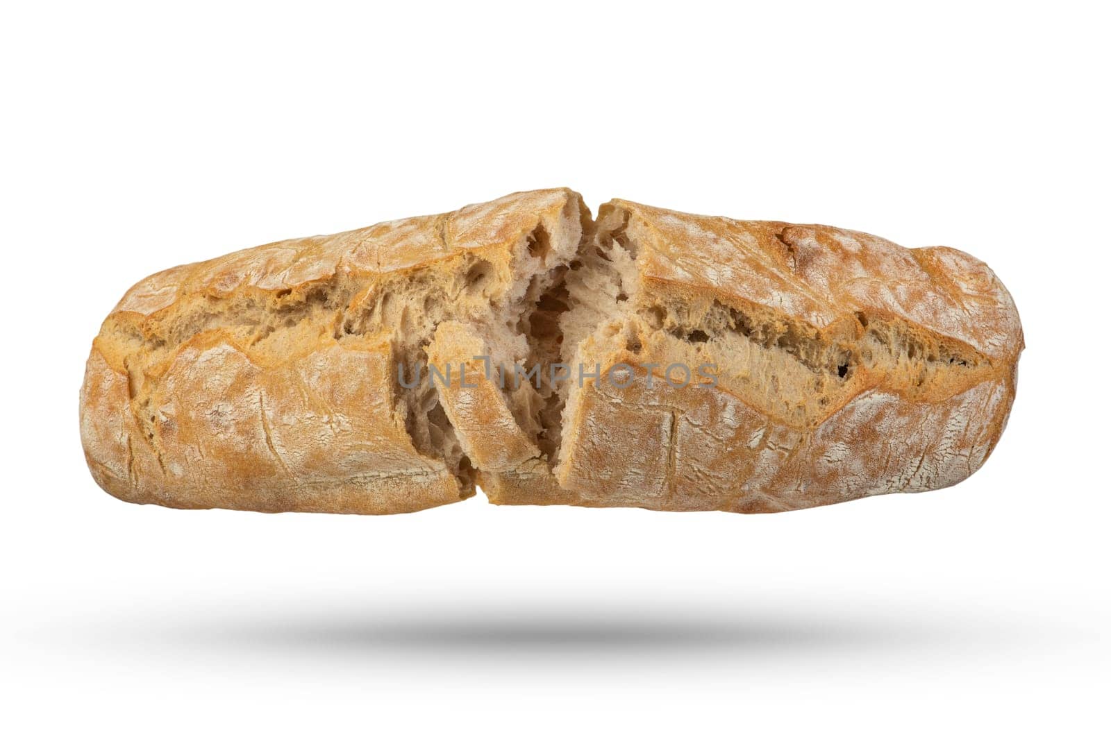 A loaf of Italian fresh ciabatta bread is broken into 2 parts on a white isolated background. Bread hanging or falling on a white background. Italian bread, top view. by SERSOL