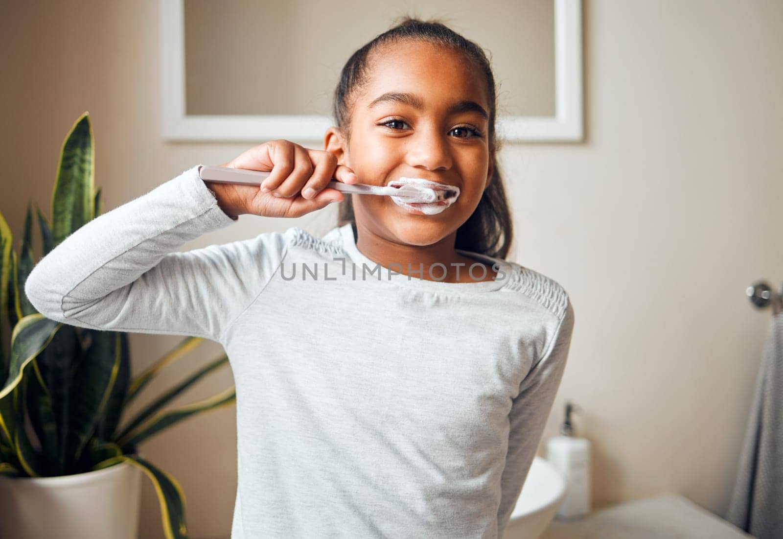 Girl brushing teeth, portrait and toothbrush for hygiene with clean mouth and fresh breath with dental health. Kid, cleaning with toothpaste in bathroom and wellness at family home with healthy gums by YuriArcurs