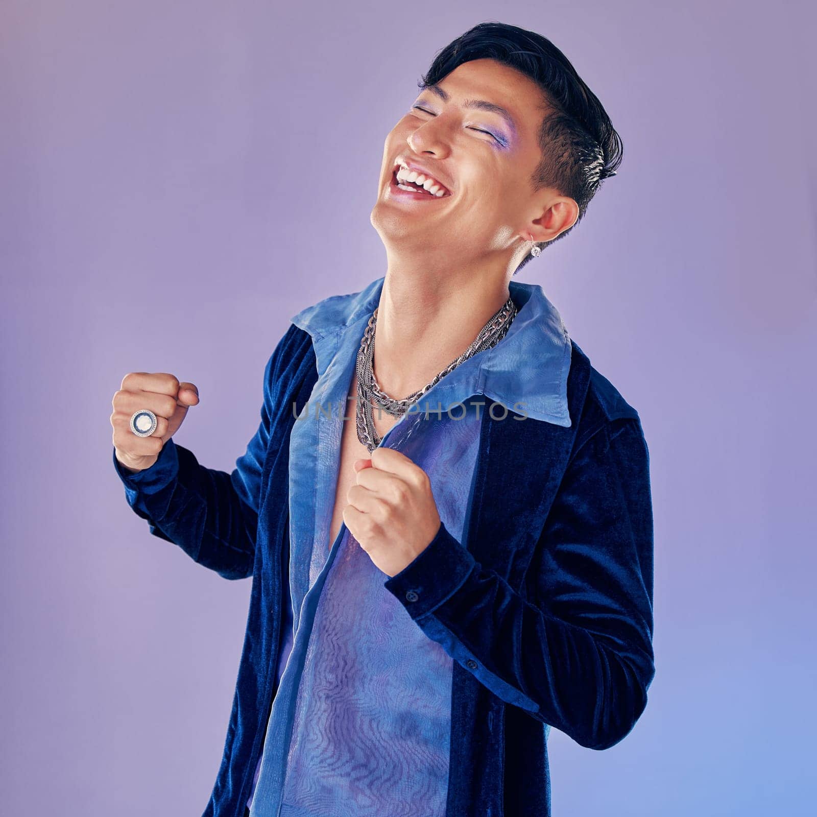 Asian model, fashion and smile with happy smile in purple studio background with clothes, cosmetics and makeup for retro style. Face beauty of an man looking trendy with laugh, happiness and joy by YuriArcurs