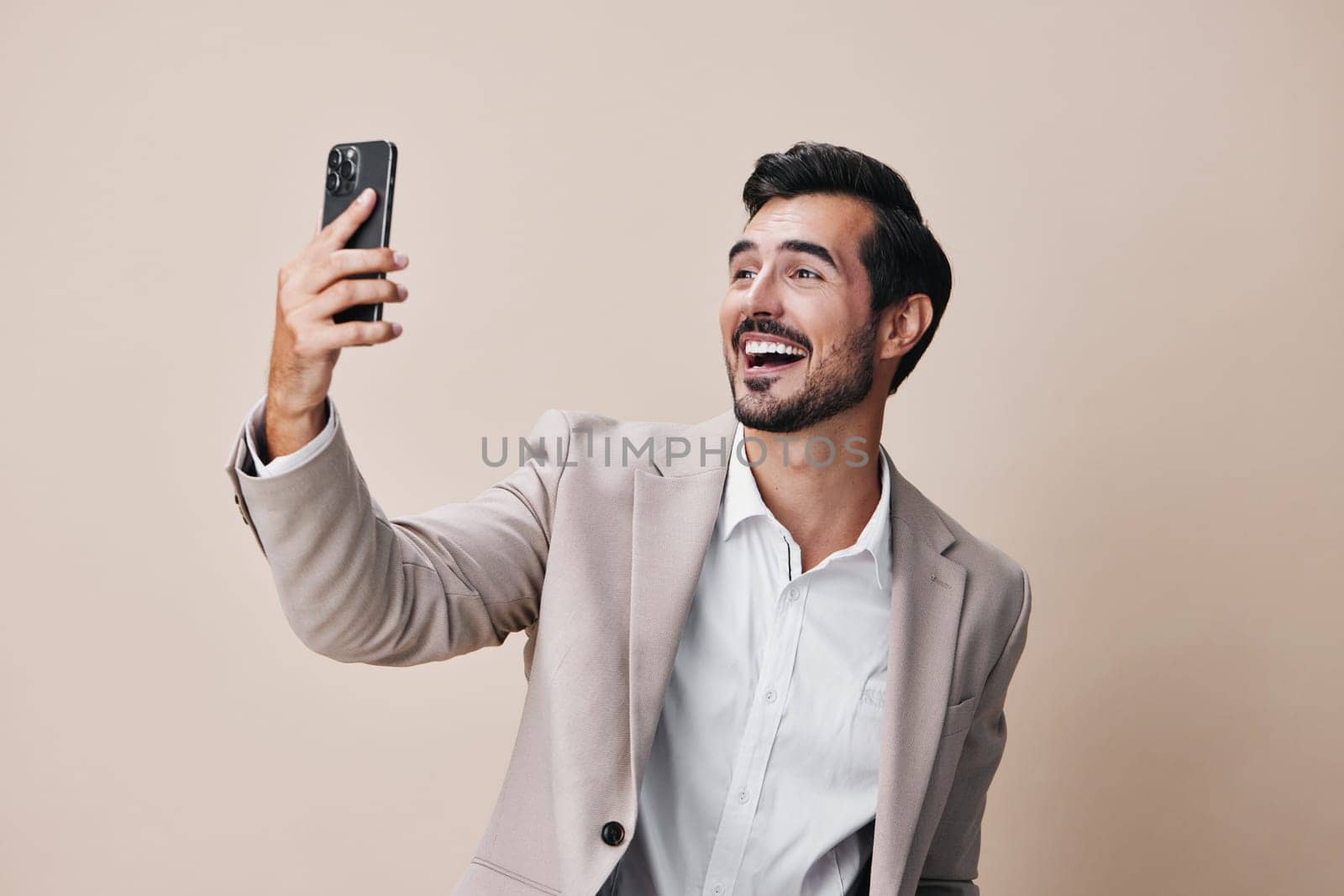 man portrait hold phone happy app business smartphone suit smile call by SHOTPRIME