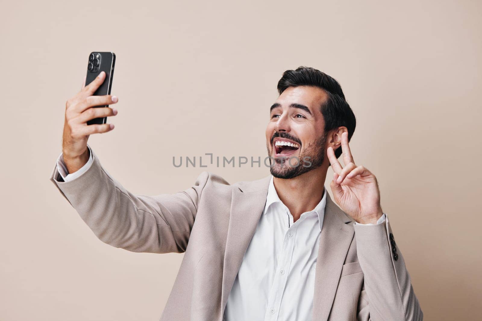 hold man happy message handsome lifestyle suit smile studio portrait phone selfies space beard smartphone confident call success young white copy business