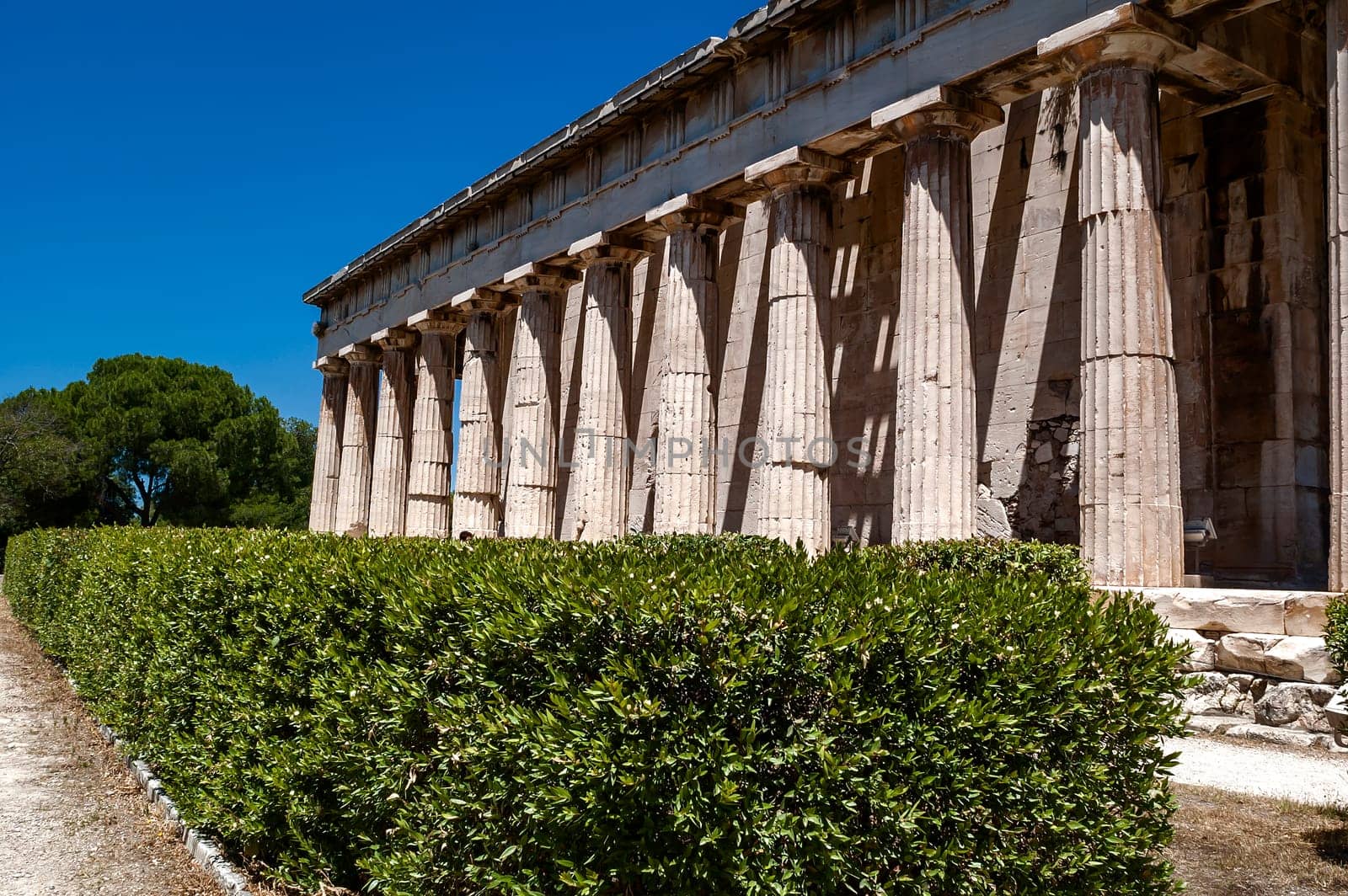 ATHENS, GREECE - 06/23/2013 - The Temple of Hephaestus in ancient market (agora) under the rock of Acropolis, Athens, Greece.