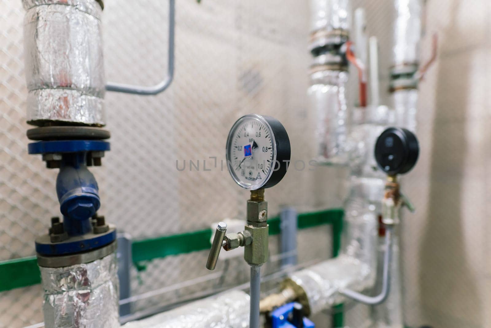 Pressure sensor in an industrial boiler room. Barometer in a heating system. Close-up.
