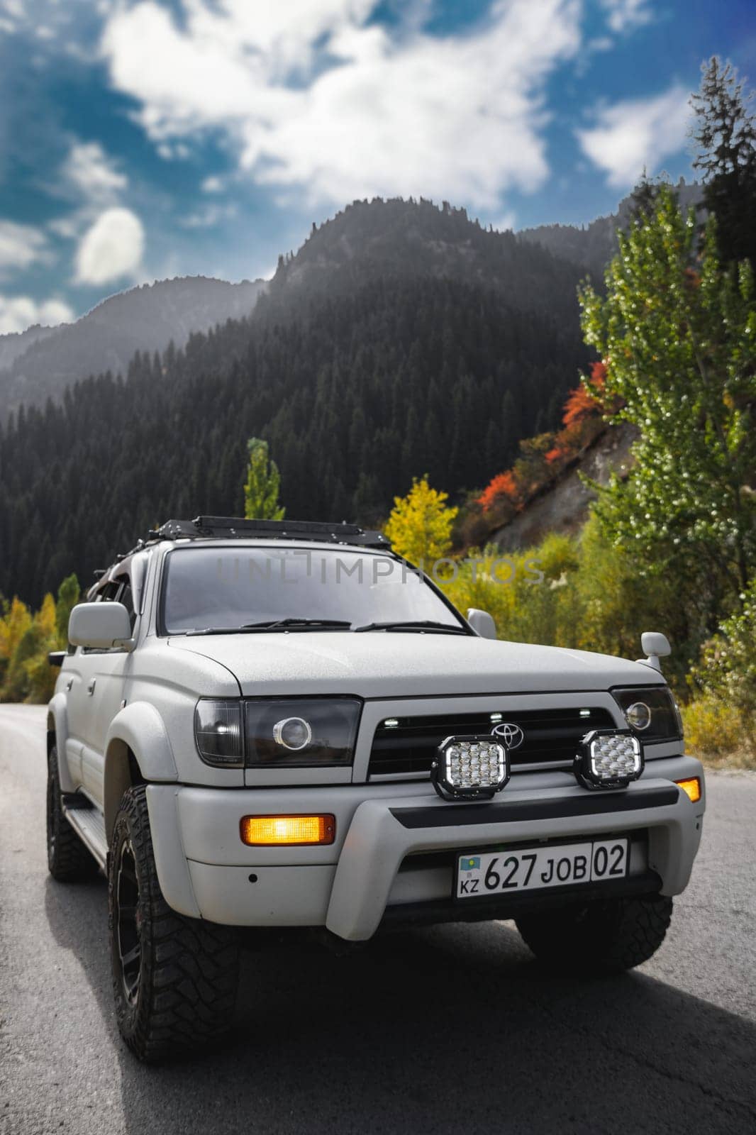 Off-road white car Toyota on mountain road. Weekend Vacation car adventure. Almaty, Kazakhstan - September 28, 2022