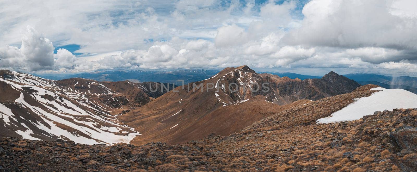 Panoramic delightful view of the steep snowy slopes on a cloudy day in the Pyrenees mountains on the sky. Concept of south european mountain nature. Copyspace by apavlin