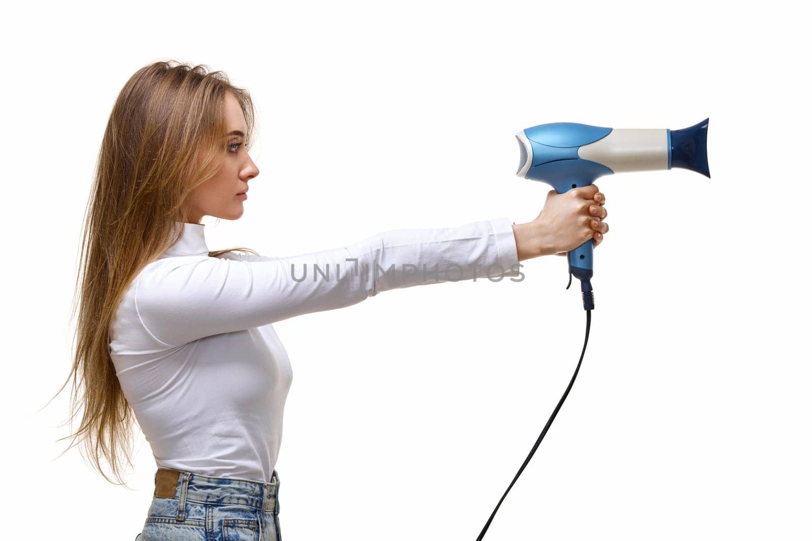 Portrait of attractive cheerful girl with long hair holding hair dryer isolated on white background