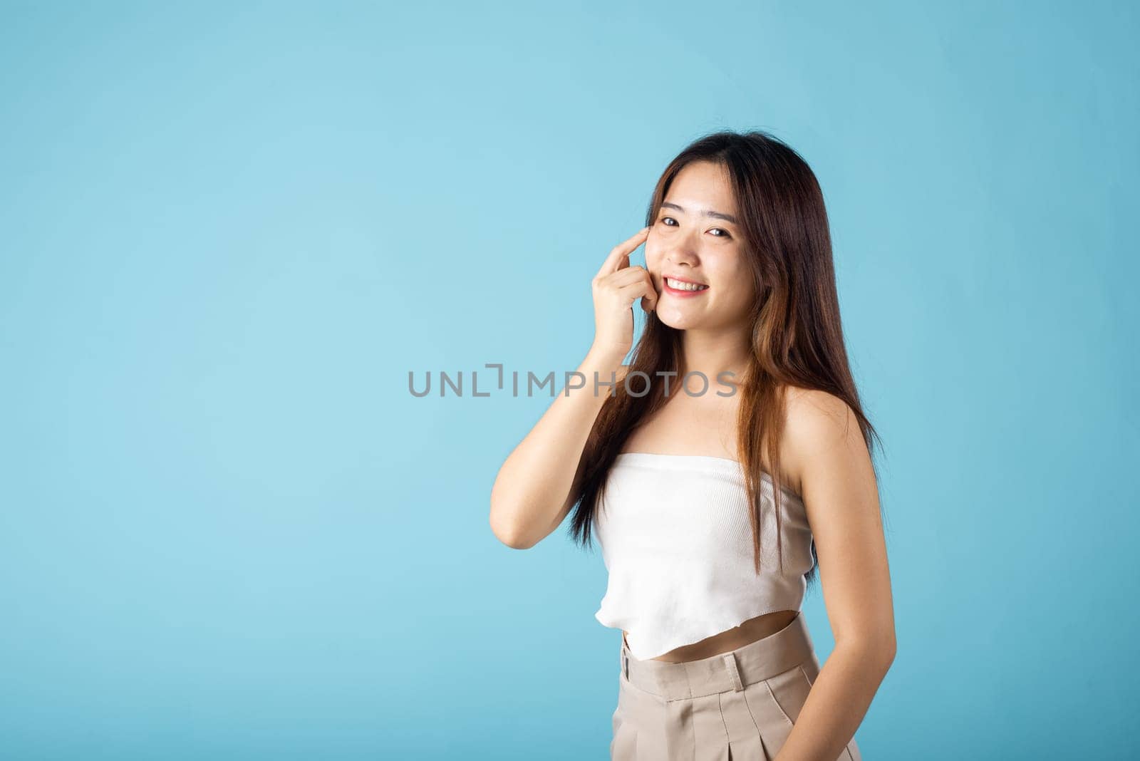 Asian woman with beauty face touching healthy facial clean skin by Sorapop