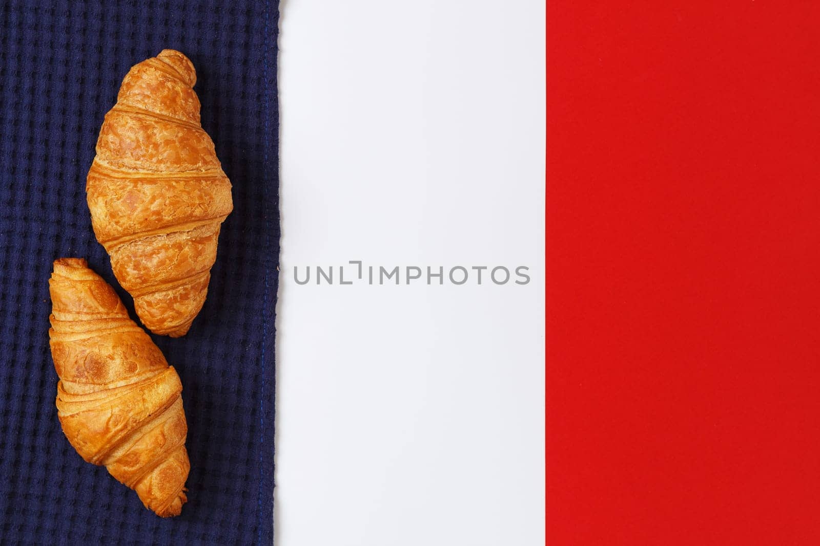 Delicious croissants on textiles in the form of the flag of France. copy space.