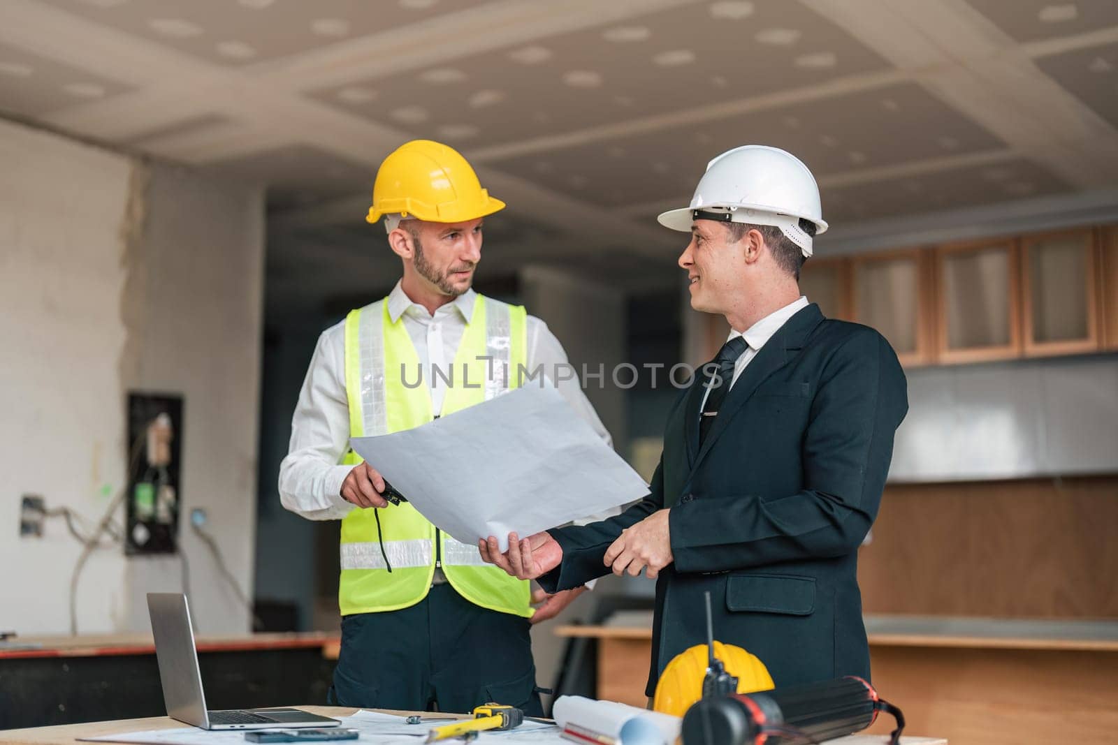 Professional construction engineers team using blueprint of project plan brainstorming and working together at construction building, Architecture and building construction concept.