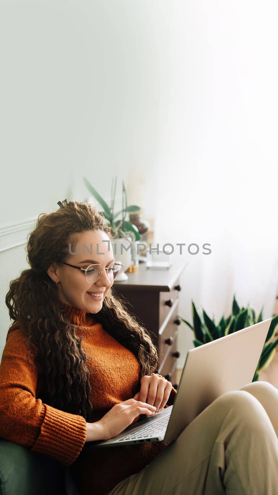 Relaxed Young woman on sofa surfing the internet, shopping and learning. Online shopping, learning and entertainment with a relaxed woman at home