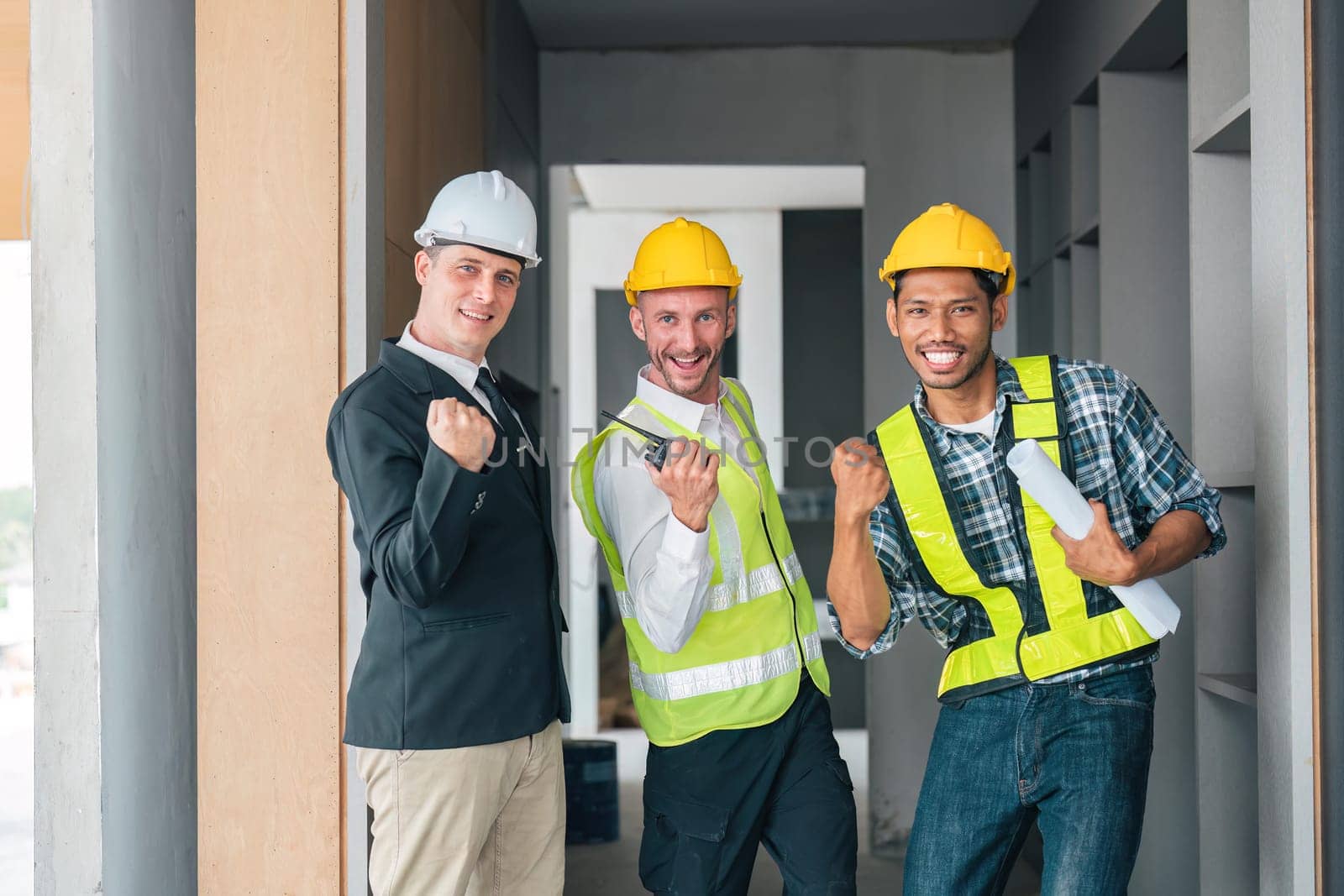 team man engineers success cheerful and protective helmet construction site industrial project in working site by nateemee