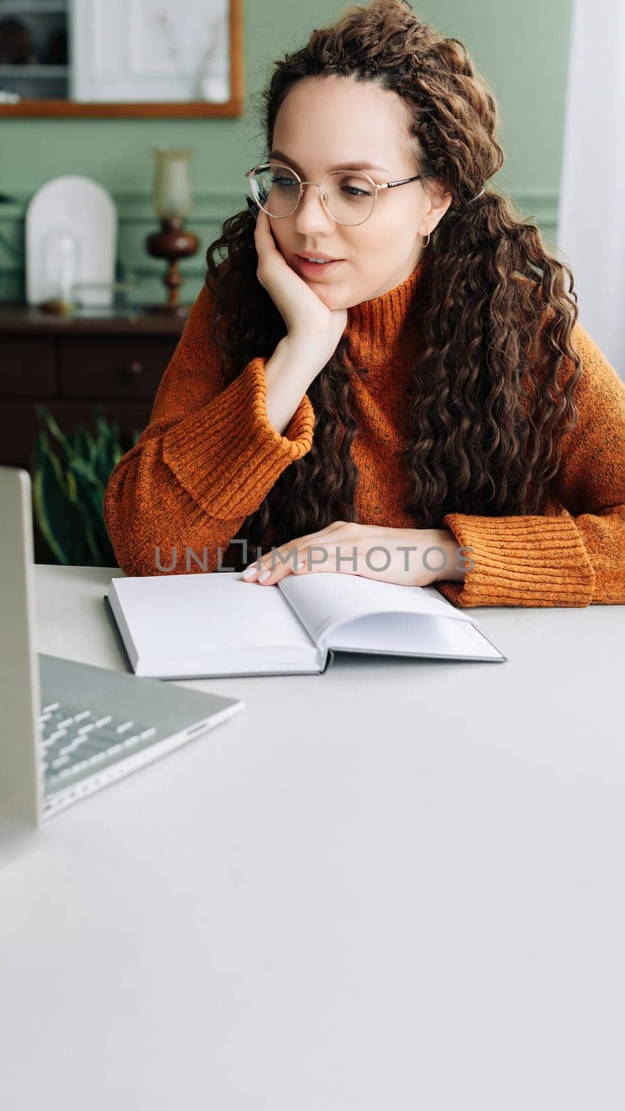 Contemplative Young Woman Taking Breaks from Online Learning and Working on Laptop at Home. Young Woman Studying and Working from Home, Lost in Thought and Contemplating Ideas on Her Laptop