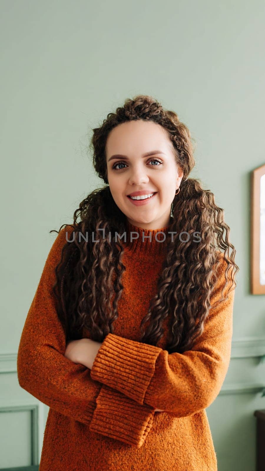 Happy Professional Woman Laughing in Modern Living Room - Portrait of Cheerful Lady Smiling for Camera in Cozy Apartment or Office.
