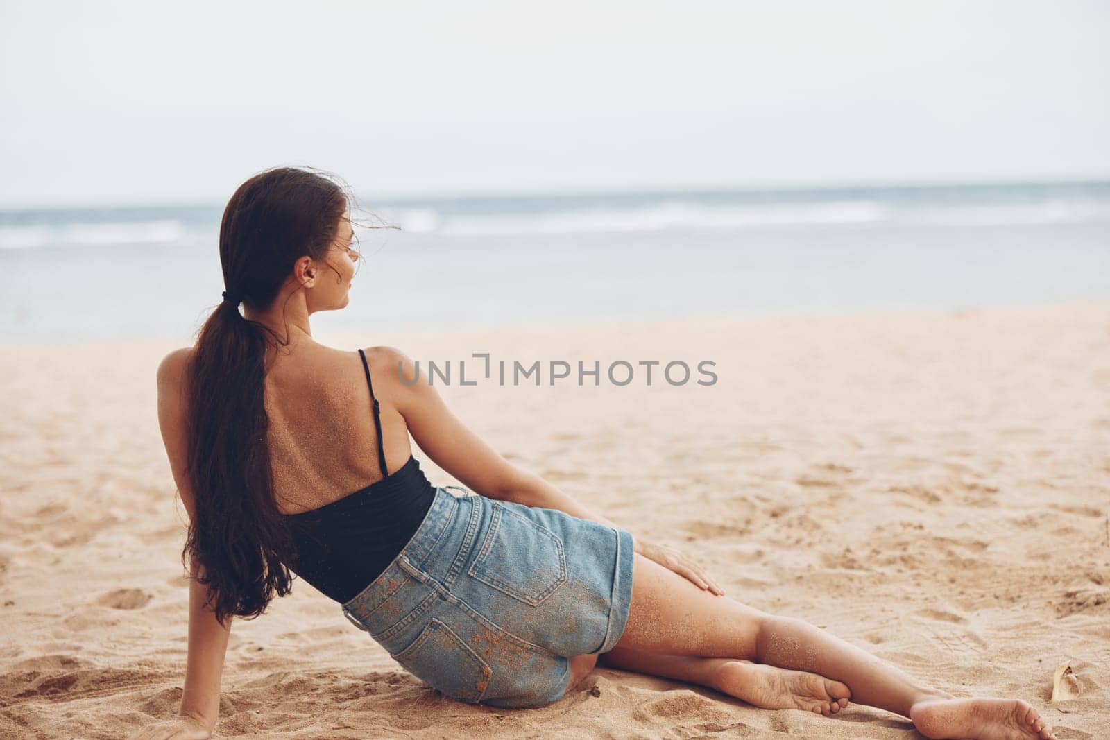 female woman sitting smile nature sea caucasian vacation white model travel natural coast body sand beach tan young freedom summer carefree