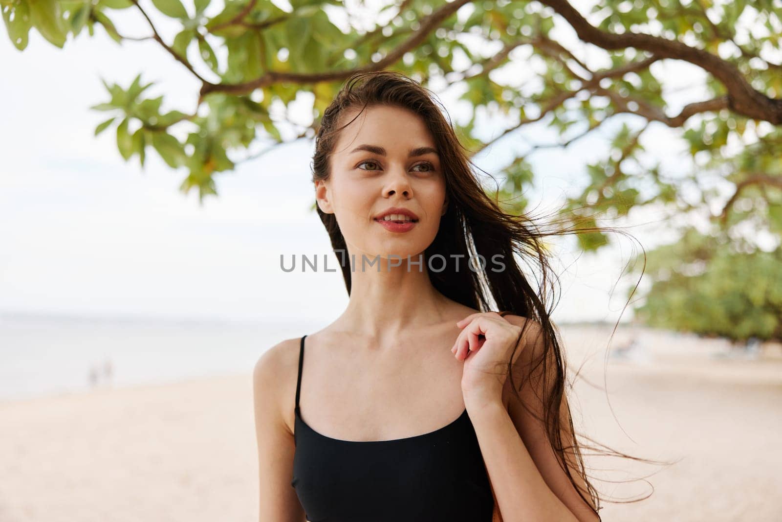 woman carefree girl sand sky vacation ocean summer beach young tropical happy shore sea adult copy-space beauty smile nature freedom happiness