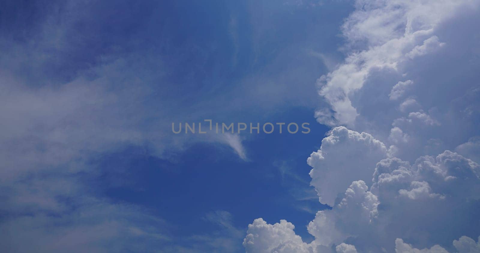 Blue sky and white cumulus clouds texture background. Blue sky on sunny day. Beautiful blue sky. World Ozone Day. Ozone layer. Summer sky. Beauty in nature. Nice weather in summer season. Summer day. by Fahroni