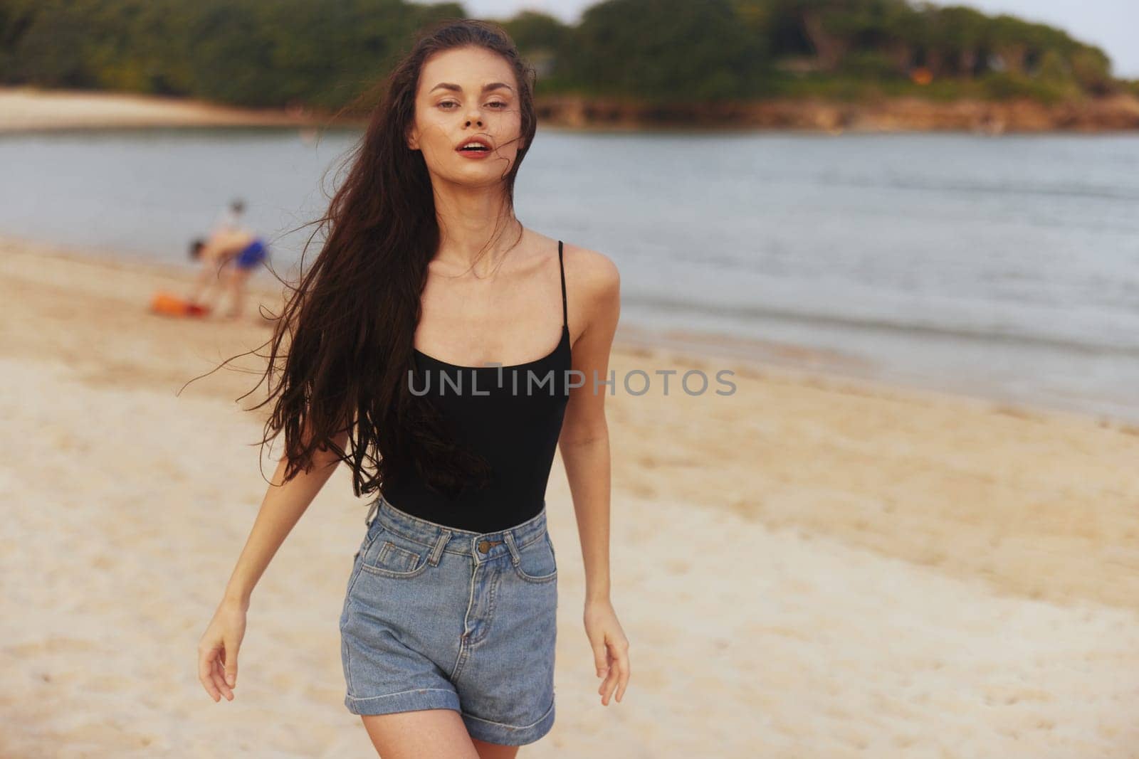 woman ocean dress adult sunset lifestyle person young beach sun summer shore tropical sea sunlight walking sand smile enjoyment vacation happiness