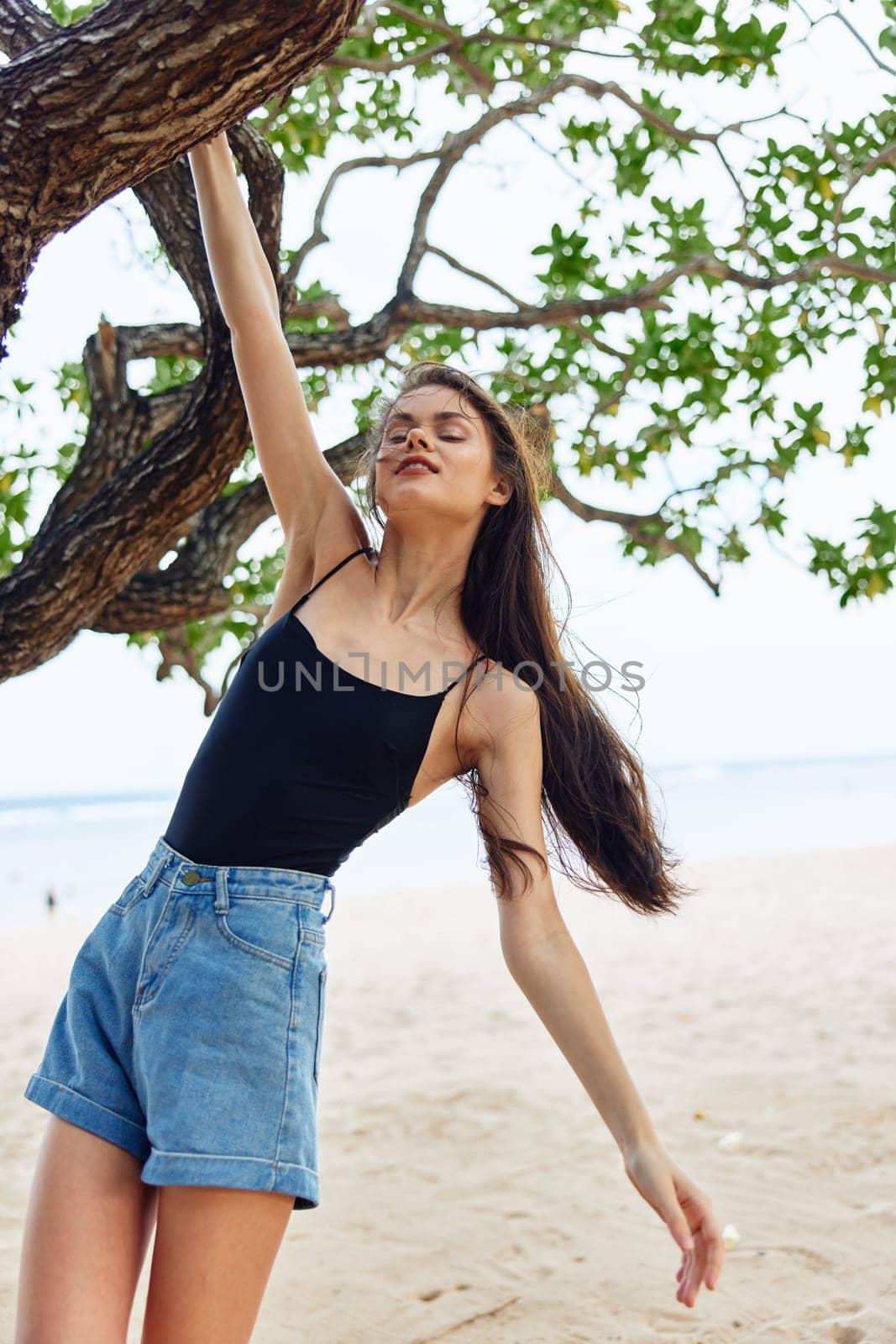 hanging woman lifestyle vacation relax holiday smiling tree sky nature sea by SHOTPRIME