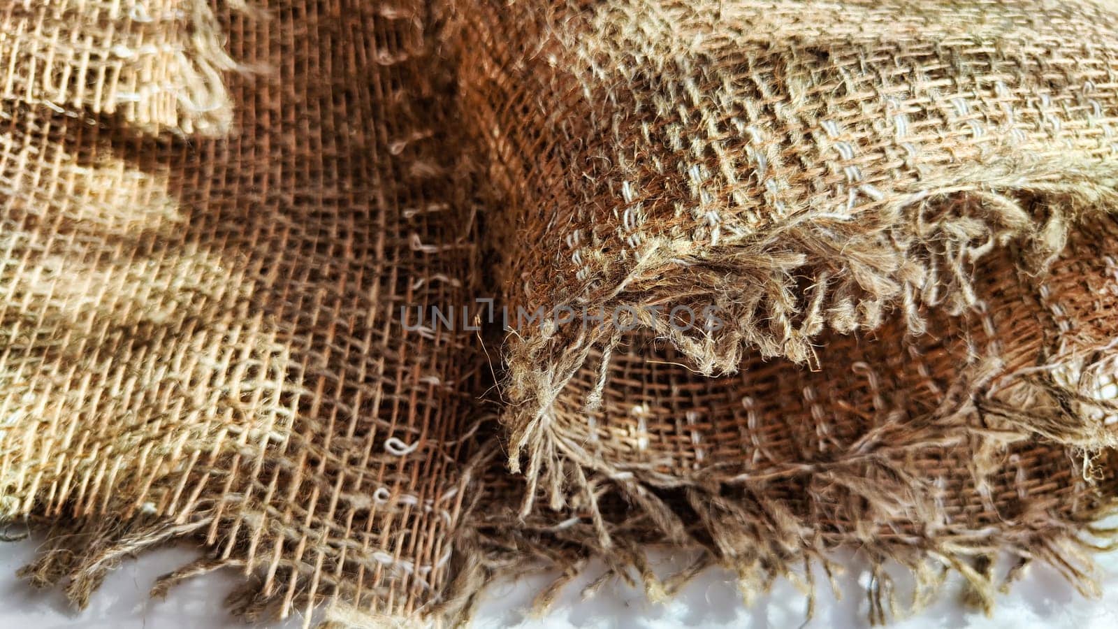 Natural fabric texture, frame and background of burlap. Rough crumpled burlap background. Selective focus