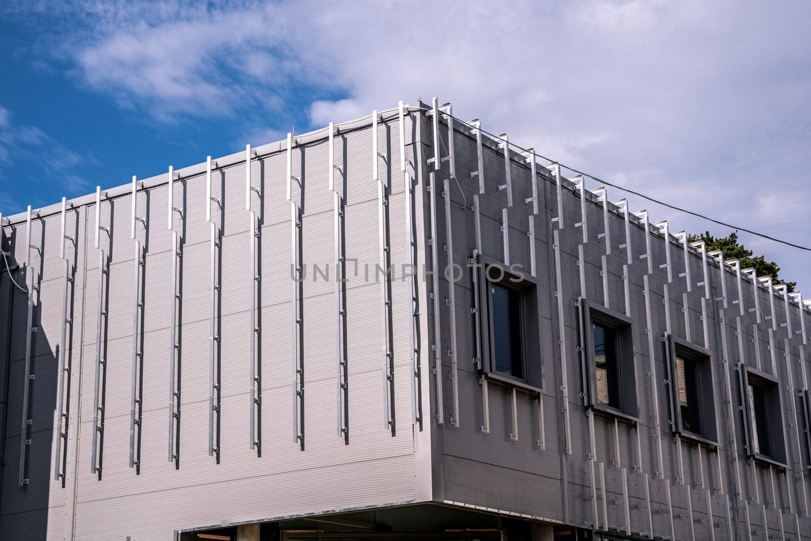 exterior walls of the building for cladding facades with decorative panels. crate on the facade of the building. Building house, installation of galvanized crate