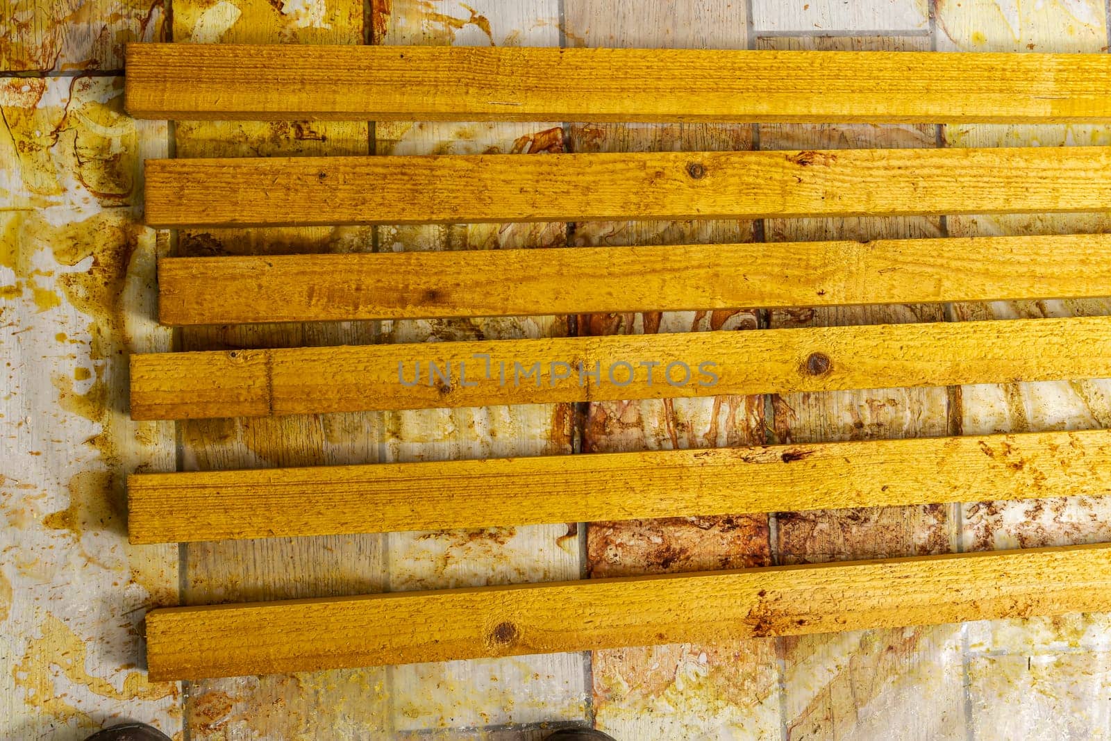 painted wooden slats dry on the floor in the workshop by audiznam2609