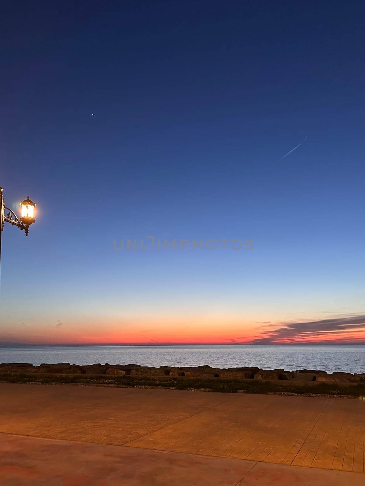 Orange glow on the sea horizon after sunset, mobile photo. High quality photo